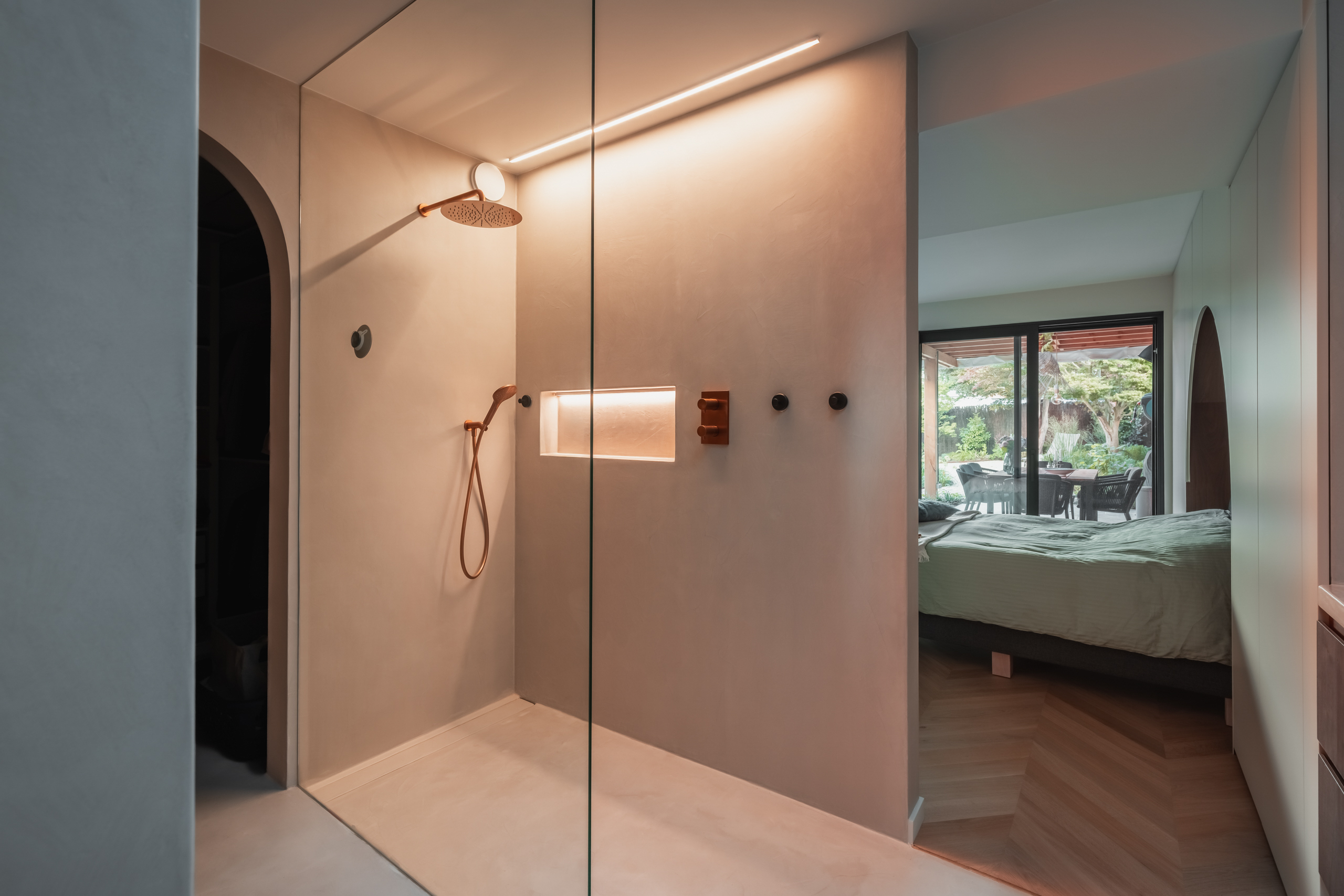 Open seamless en-suite bathroom visually connected to adjacent rooms in Evergem
